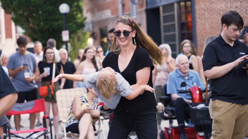 Woman in Illinois dancing with her child, enjoying being outside in Champaign and Urbana’s hidden gems